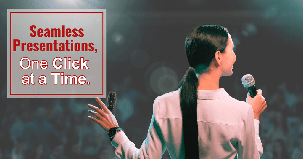A woman on stage confidently speaks to the crowd, using a wireless presentation clicker.